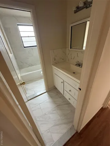 a white toilet sitting next to a bath tub