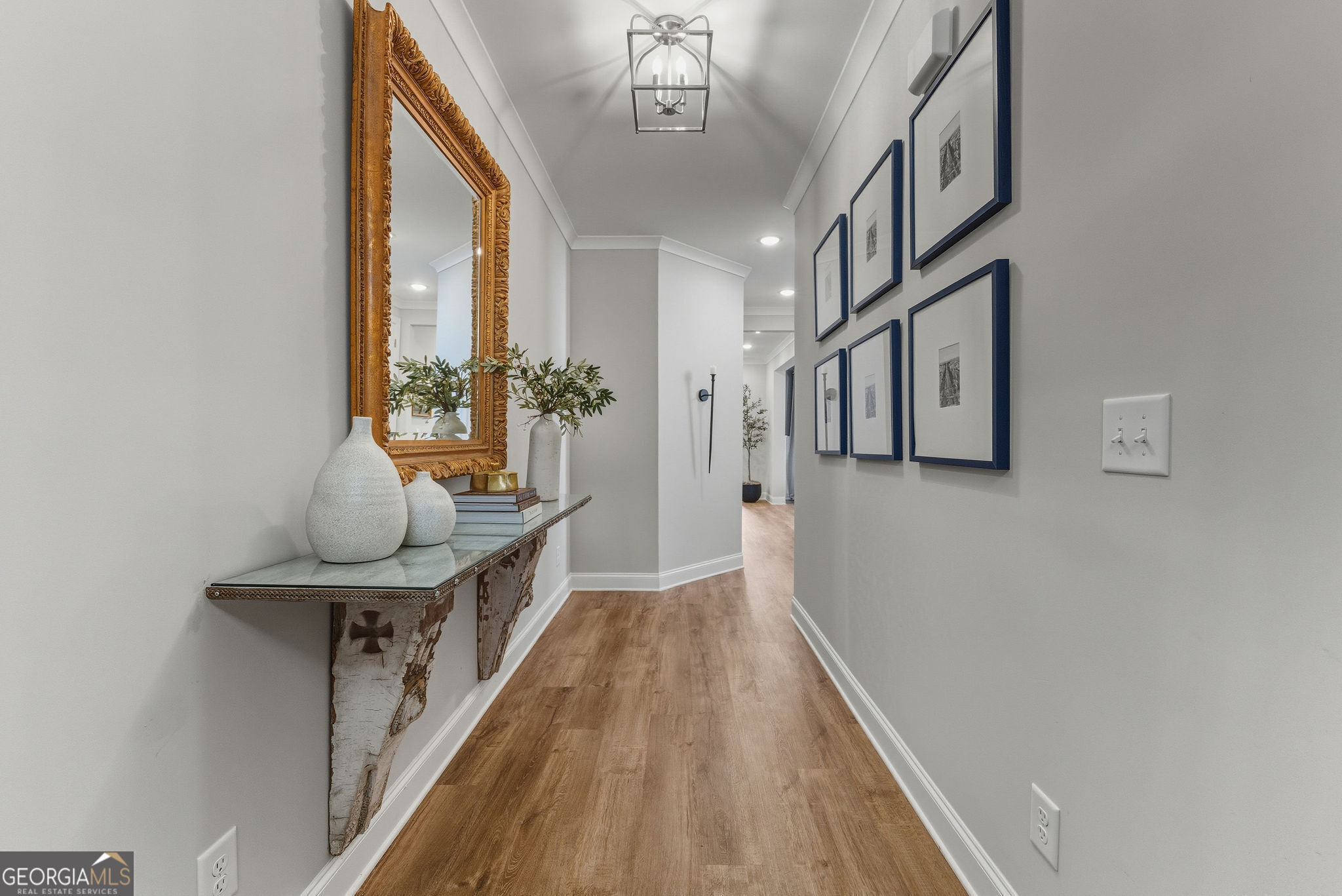 1140 Providence Loop Greensboro, GA 30642 - Photo 4 of 23 a hallway with a large window and chandelier
