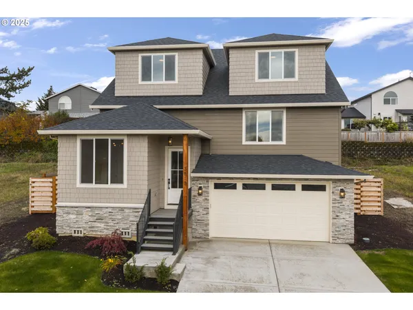 a front view of a house with a yard and garage