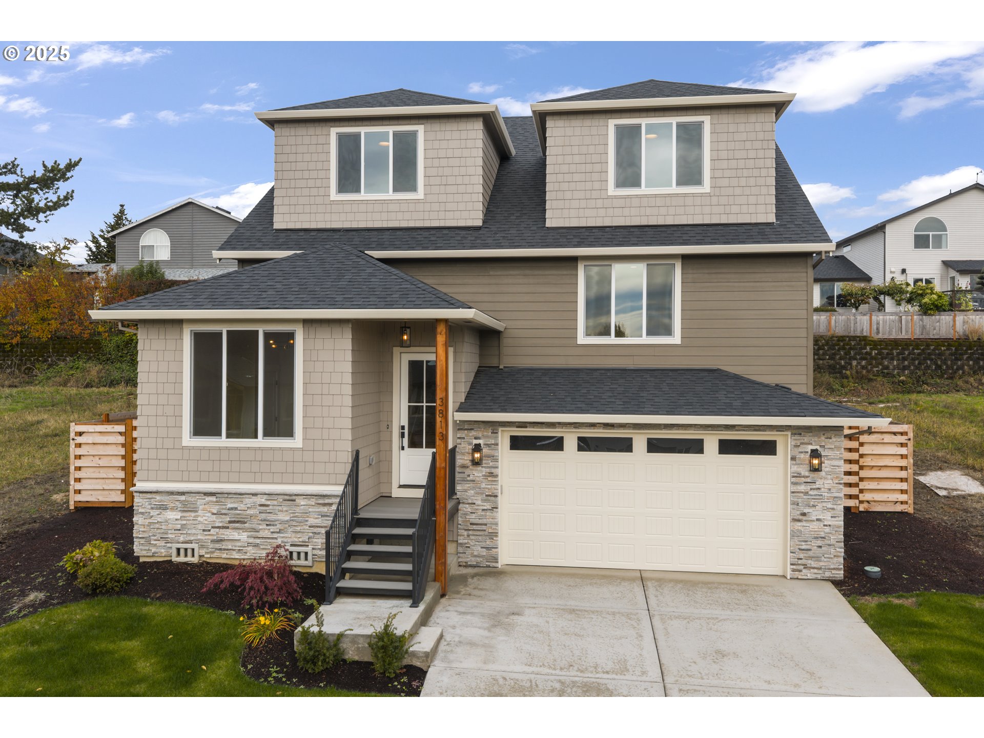 a front view of a house with a yard and garage