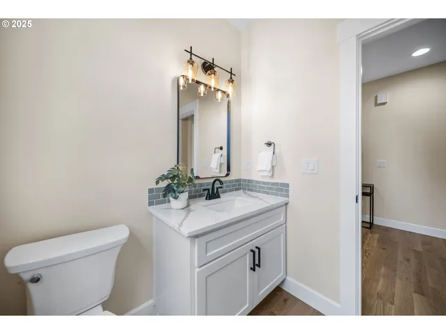 a bathroom with a sink a toilet and mirror