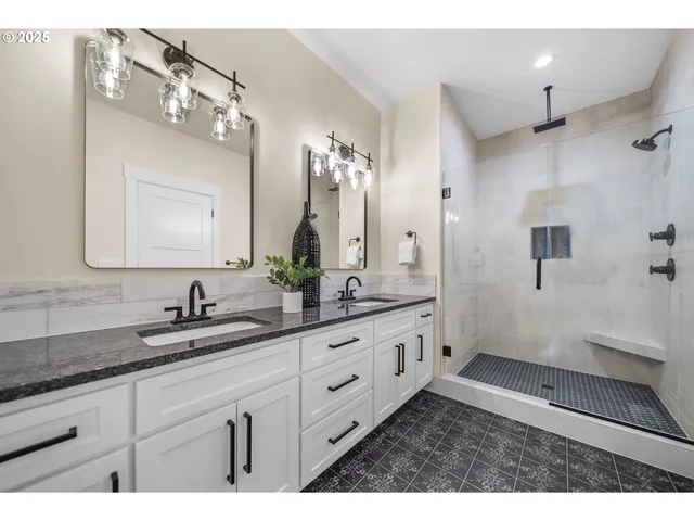 a bathroom with double sink and a mirror