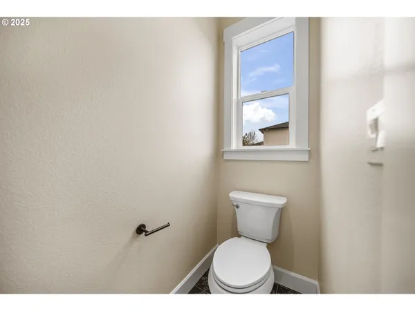 a bathroom with a toilet a sink and a window