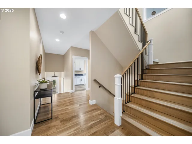 a view of entryway and hall with wooden floor