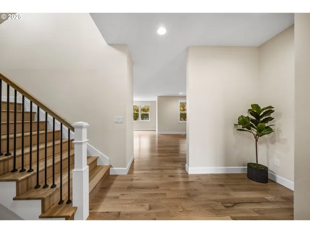 a view of entryway and hall with wooden floor