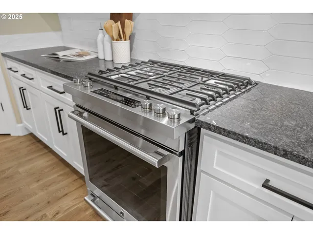 a stove top oven sitting inside of a kitchen