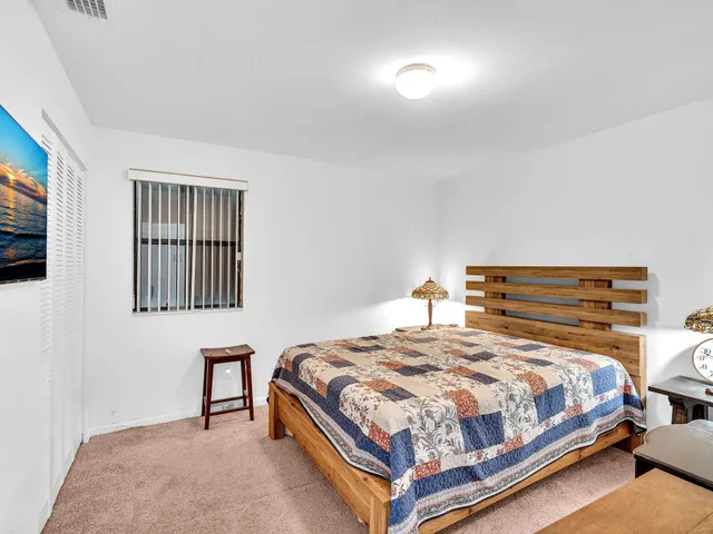 a bedroom with a bed and a night stand