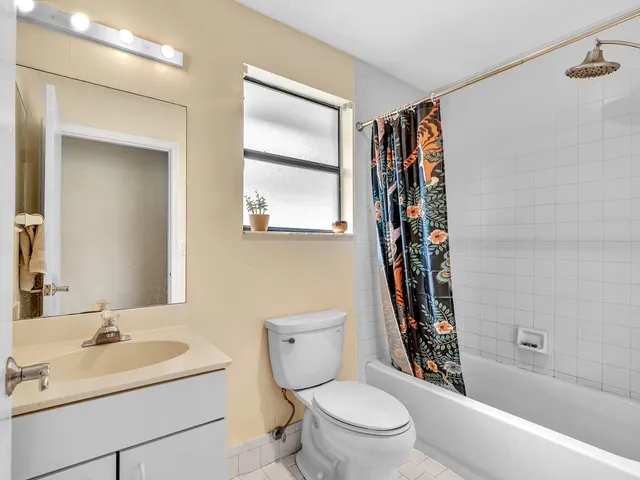 a bathroom with a toilet sink and shower