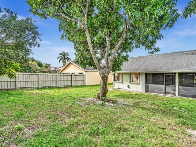 a house with green field in front of it