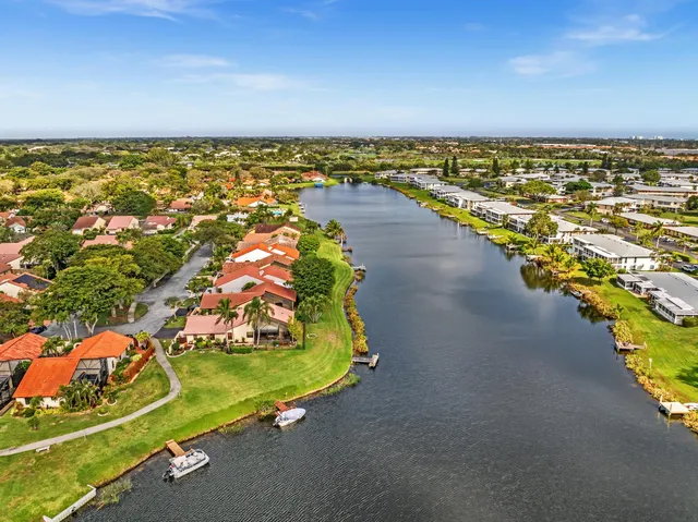 a living room with furniture kitchen view and a window