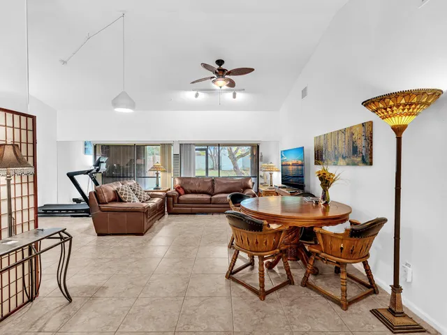 a living room with furniture a chandelier and a window