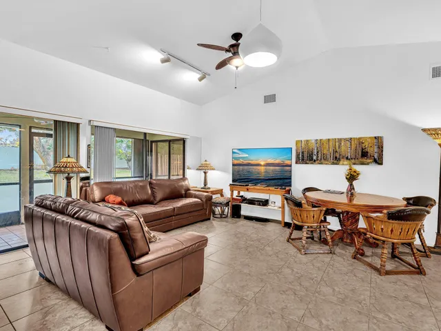 a living room with furniture and a ceiling fan