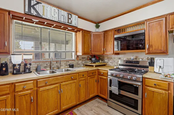 a kitchen with stainless steel appliances a stove sink and cabinets