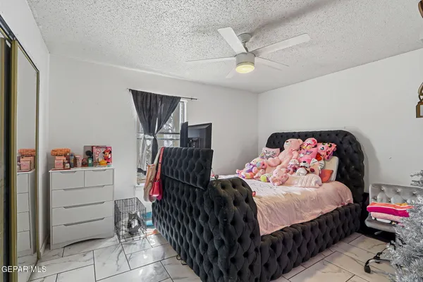 a bedroom with bed and a chair