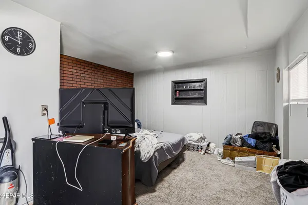 a bedroom with a bed and flat screen tv