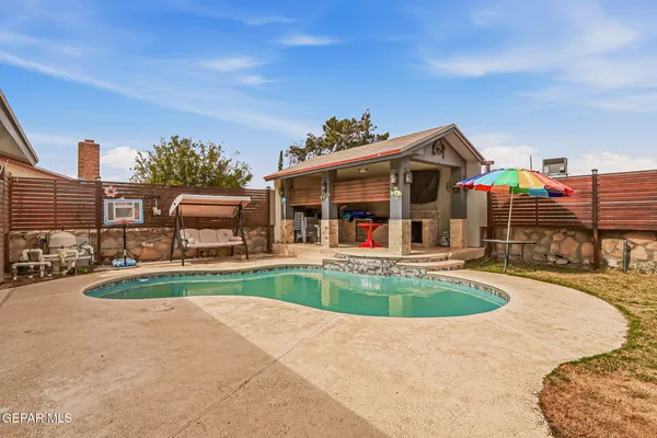 a view of a house with backyard porch and sitting area