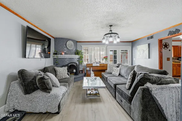 a living room with furniture a fireplace and a window