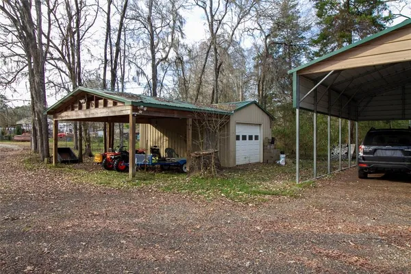 a view of a house with a yard and sitting area