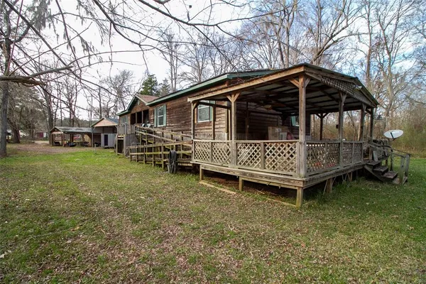 a view of a house with a yard and sitting area