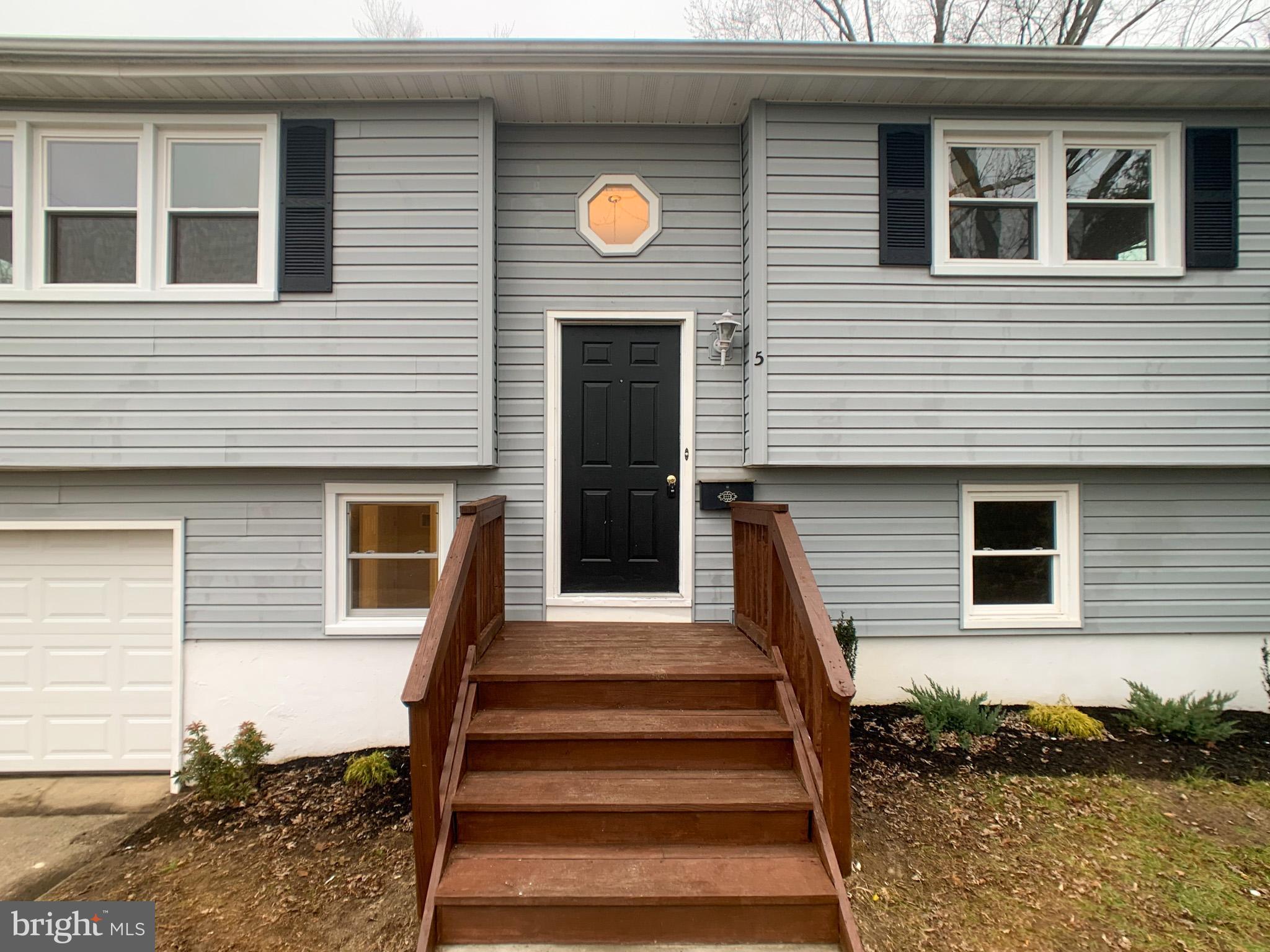 5 Estate Road Pemberton, NJ 08068 - Photo 5 of 25 a front view of a house with stairs and windows