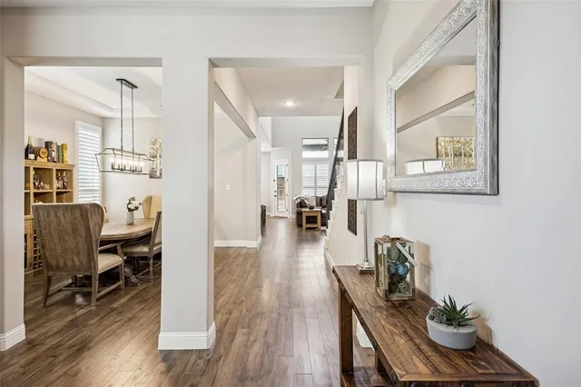 a view of a dining room with furniture a rug and wooden floor