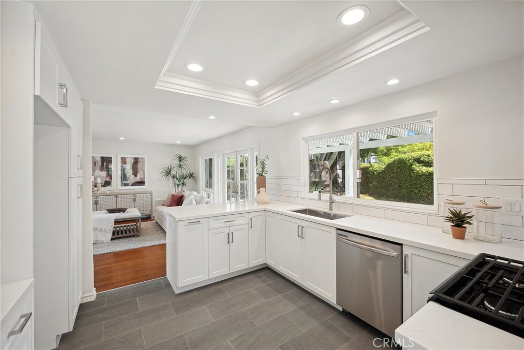 601 Calle Miguel San Clemente, CA 92672 - Photo 13 of 46 a large white kitchen with a sink and stove top oven