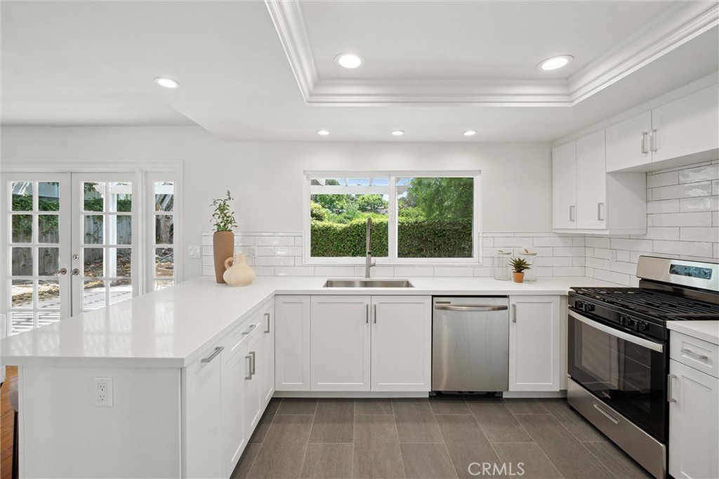 601 Calle Miguel San Clemente, CA 92672 - Photo 14 of 46 a kitchen with a sink stove and cabinets