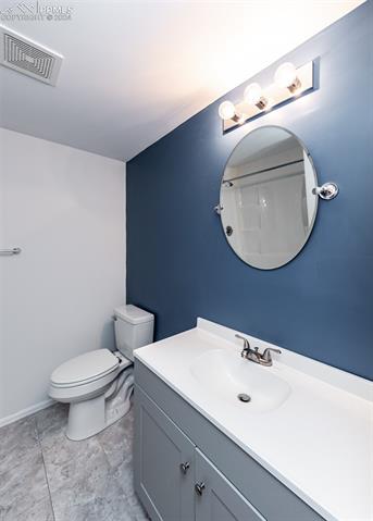 995 Winebrook Way Fountain, CO 80817 - Photo 40 of 44 Bathroom with tile flooring, oversized vanity, and toilet