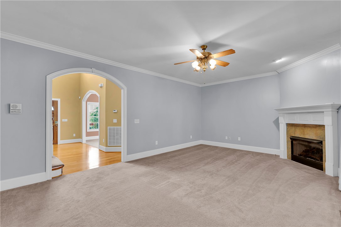 406 Hopewell Ridge Anderson, SC 29621 - Photo 13 of 46 This inviting living space features an elegant fireplace, an arched entryway, and crown molding.