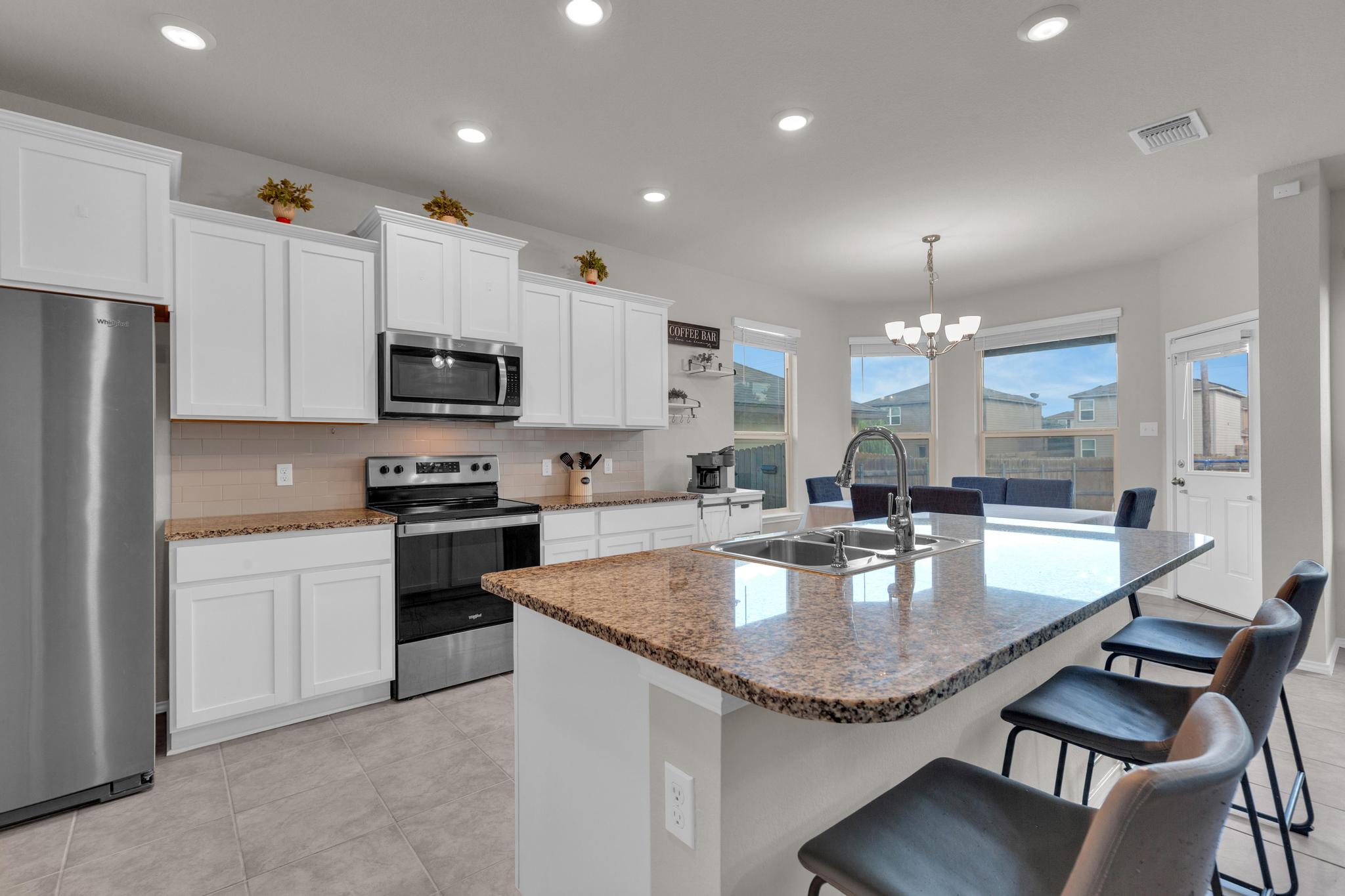 104 Uncle Billy Way Jarrell, TX 76537 - Photo 16 of 38 Gleaming stainless steel appliances complement the bright white cabinetry in this well-appointed kitchen with an eat-in island.