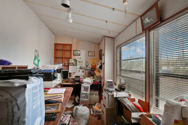 a room with furniture a flat screen tv and a window