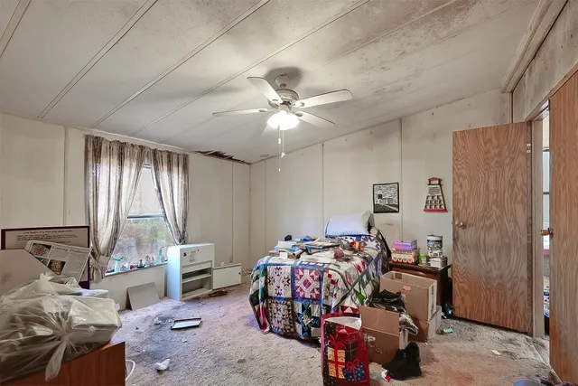 a bedroom with bed and a window