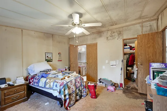 a bedroom with bed and a chandelier