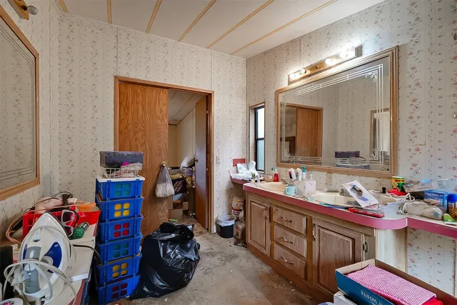 a bathroom with a sink vanity and mirror