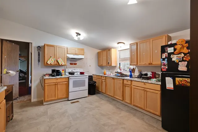 a kitchen with stainless steel appliances granite countertop a stove sink and cabinets