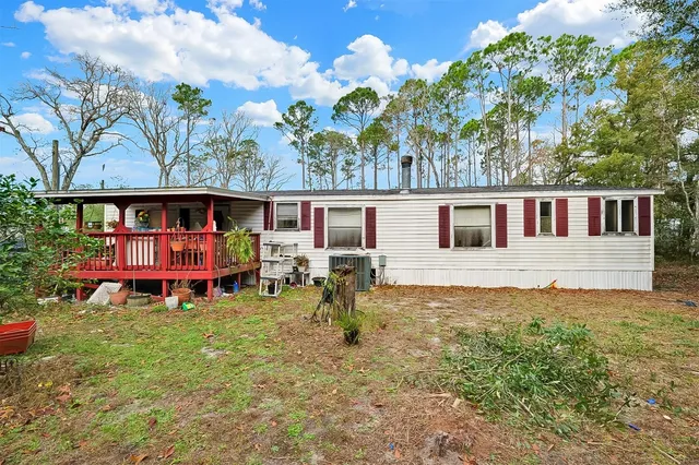 a view of swimming pool with outdoor seating and yard in the back