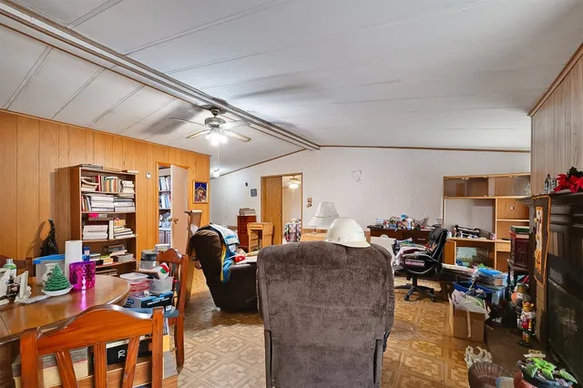 a living room with lots of furniture and a view of bedroom