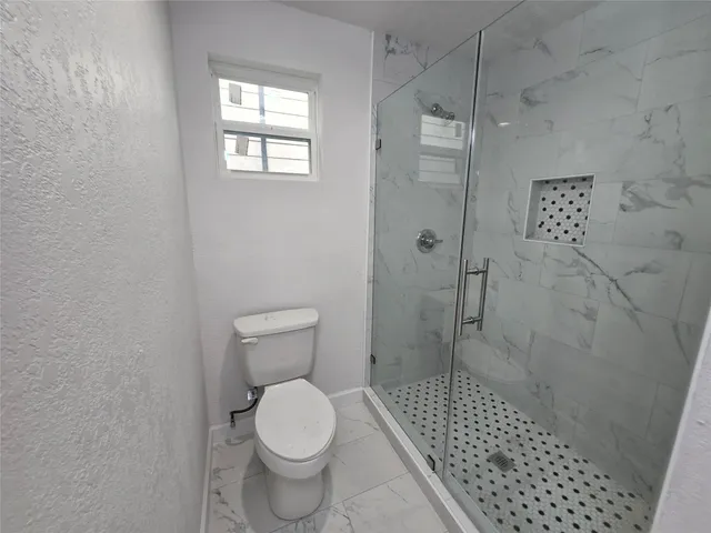 a bathroom with a sink a toilet and mirror