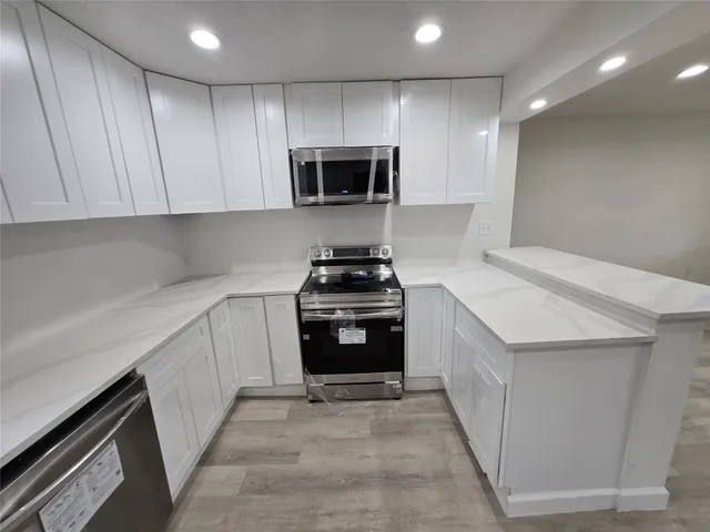 a kitchen with a sink and a stove top oven