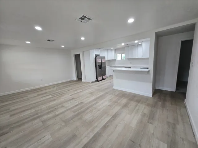 a view of a kitchen with a sink and a refrigerator