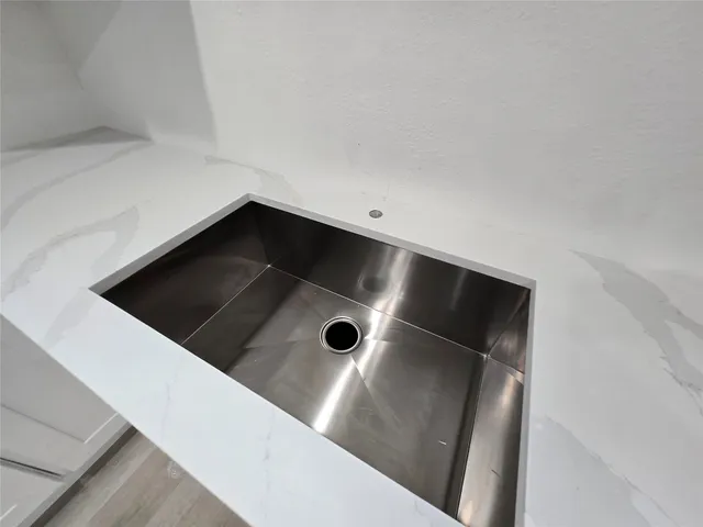 a view of a kitchen with a sink and a fireplace