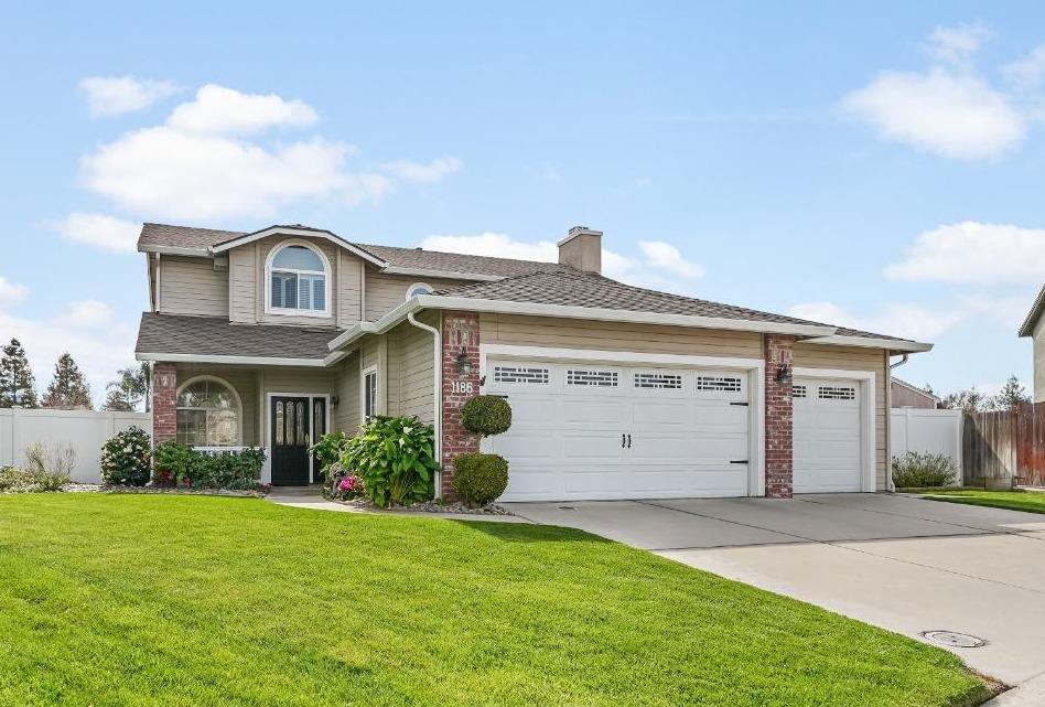 1186 Joseph Court Ripon, CA 95366 - Photo 1 of 1 a front view of a house with a garden