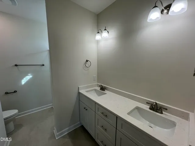 a bathroom with a double vanity sink and mirror
