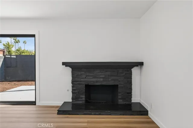 a living room with a fireplace and a fireplace