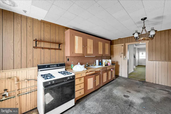 a kitchen with stainless steel appliances kitchen island granite countertop a stove a sink and a refrigerator