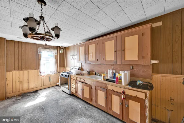 a kitchen with stainless steel appliances granite countertop a sink a stove and a refrigerator