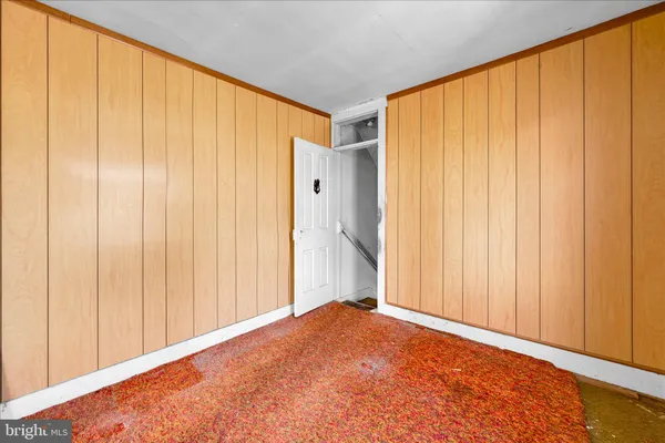 a view of a room with a wooden door