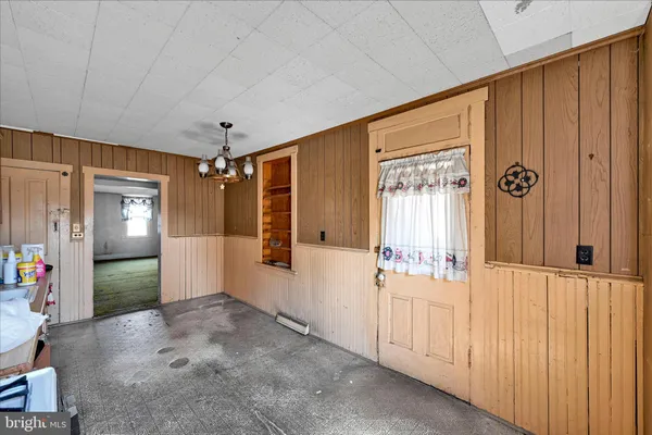 workspace with wooden floor mirror and windows