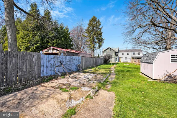 a view of a backyard with wooden fence