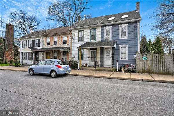 a car parked in front of a brick house
